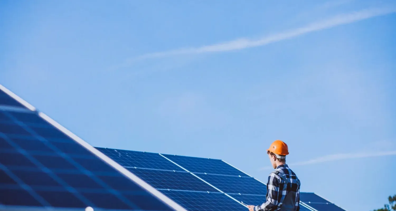 man worker in the firld by the solar panels scaled 1 35bf1baf Kadef Service
